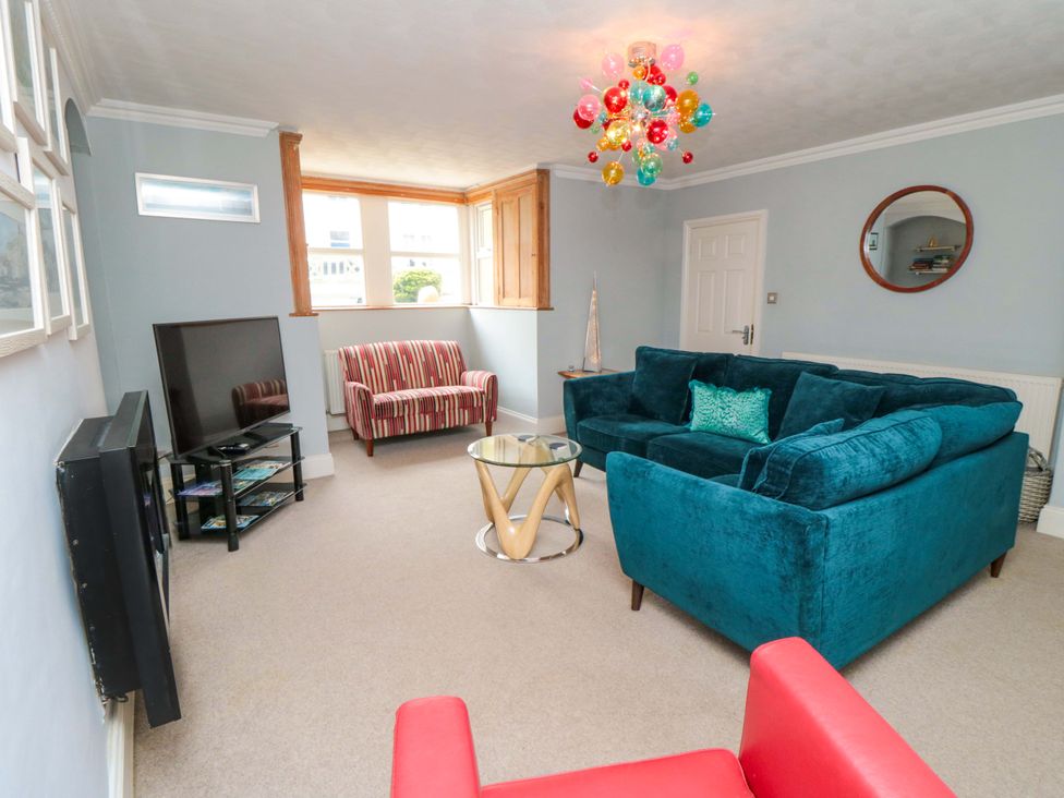 A living room with a television and sofa at The Hideaway in Whitby