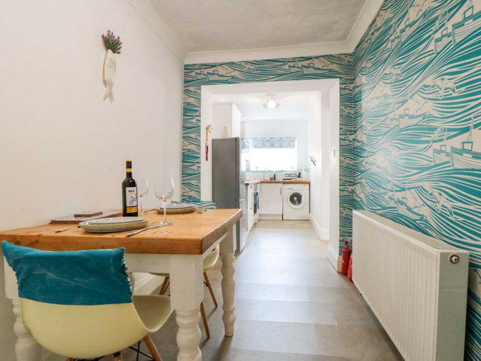 A kitchen with a table and chairs at The Hideaway in Whitby