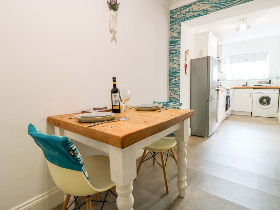 A kitchen with a dining table and chairs at The Hideaway in Whitby