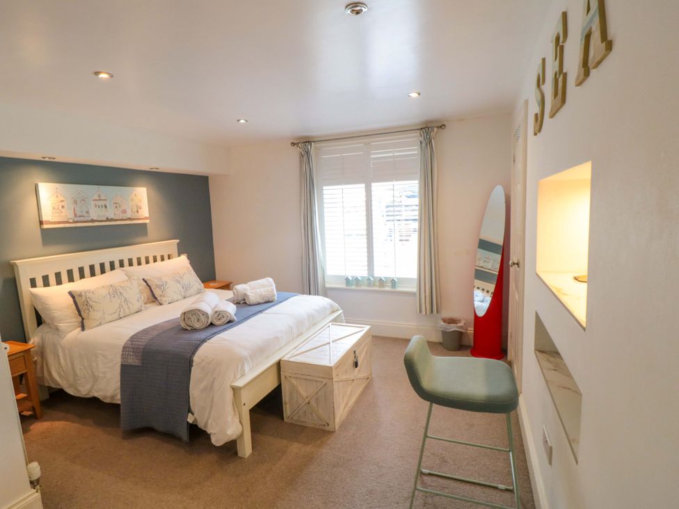 A bedroom with a bed and window at The Hideaway in Whitby