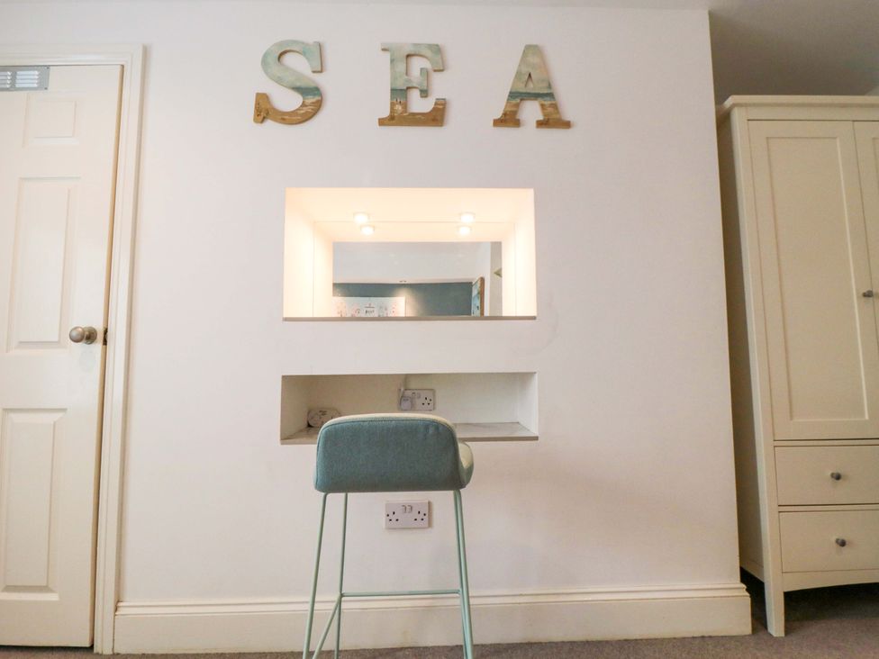 A bedroom with a desk and stool at The Hideaway in Whitby