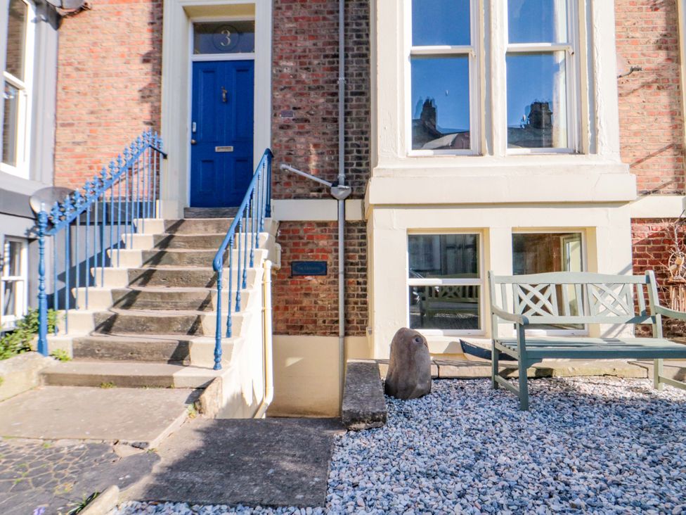 An entrance with a blue door and gravel area at The Hideaway in Whitby