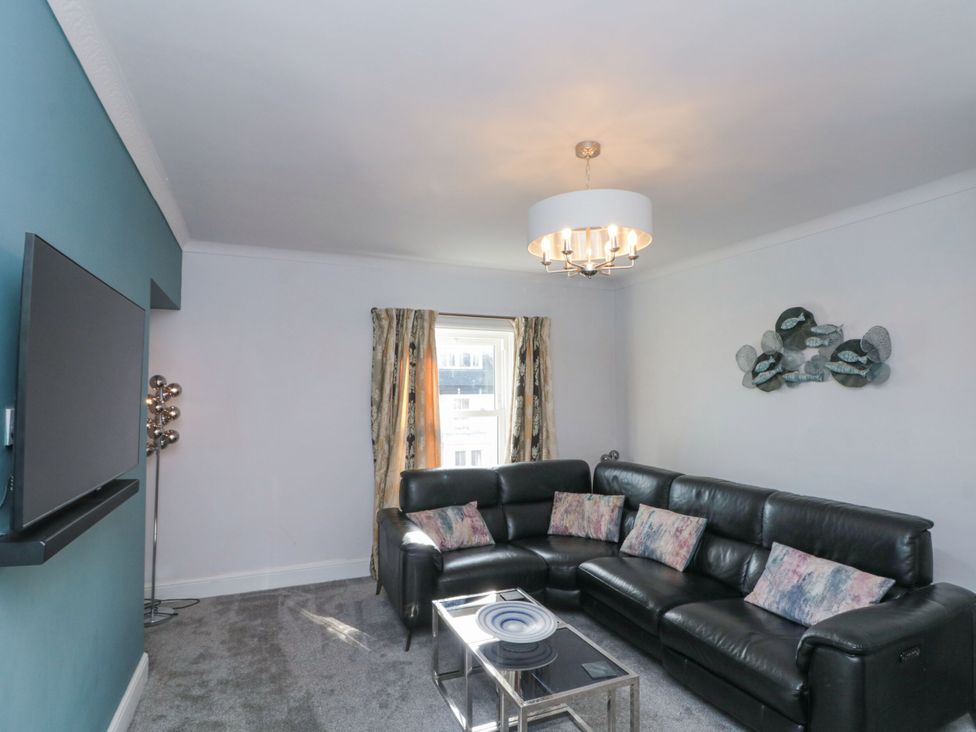 A living room with a sofa and coffee table at Cuckoo's Nest in Whitby