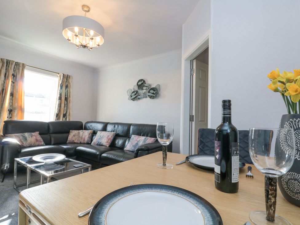 A living room with a sofa and dining table at Cuckoo's Nest in Whitby