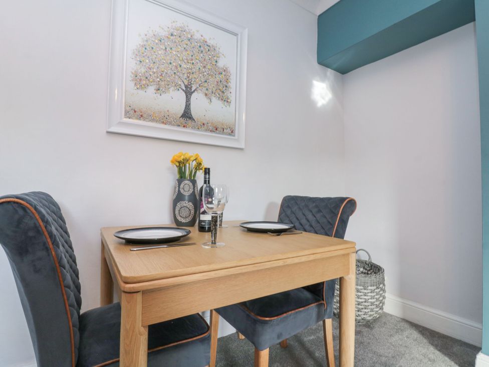 A dining room with a table and chairs at Cuckoo's Nest in Whitby