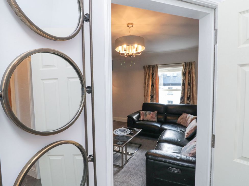 A living room with a sofa and coffee table at Cuckoo's Nest in Whitby