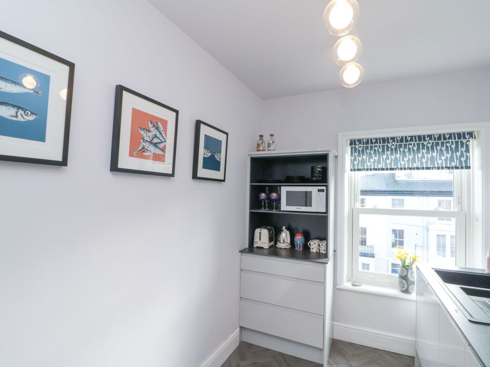 A kitchen with a microwave and kettle at Cuckoo's Nest in Whitby