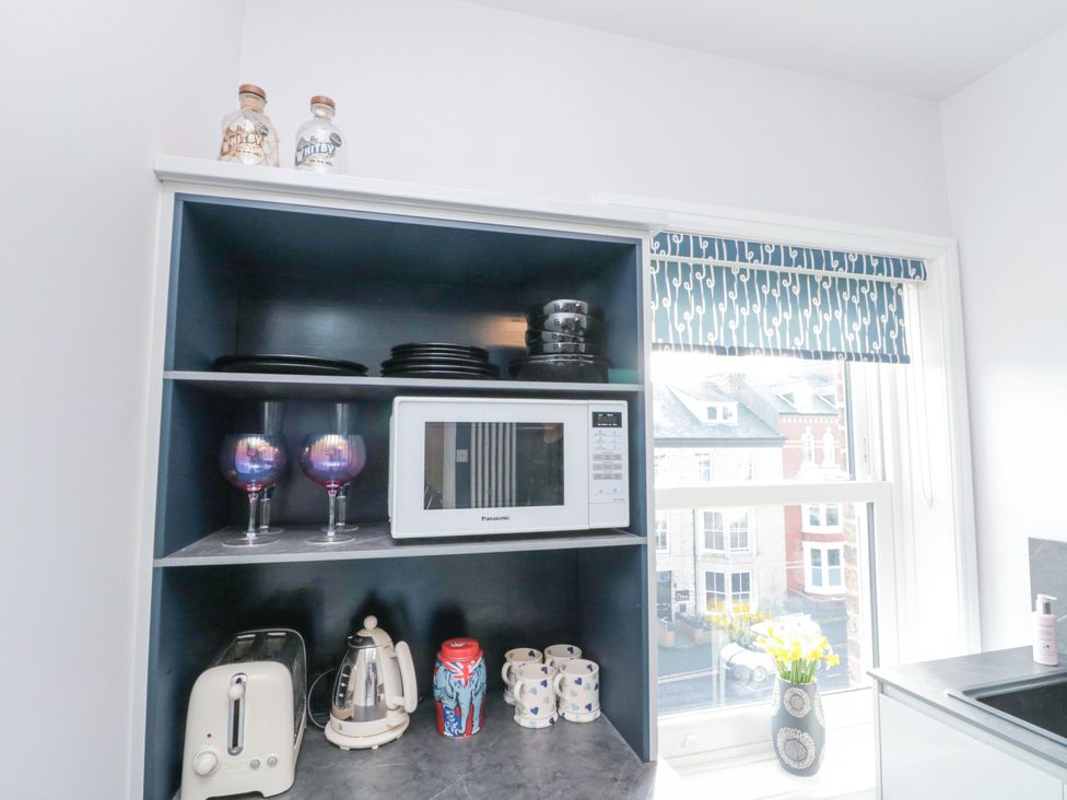 A kitchen with a microwave and utensils at Cuckoo's Nest in Whitby
