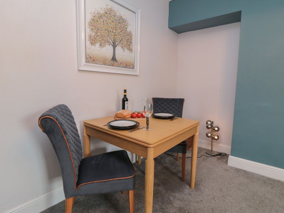 A dining room with a table and chairs at Cuckoo's Nest in Whitby