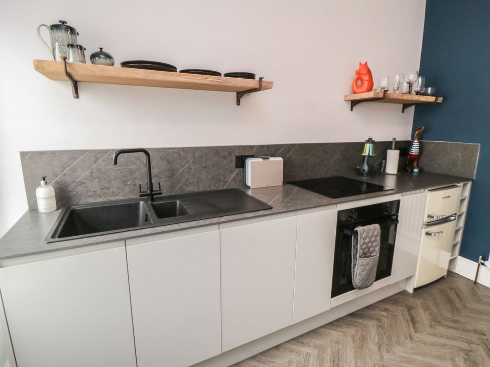 A kitchen with sink, oven, and countertop at Cuckoo's Nest in Whitby