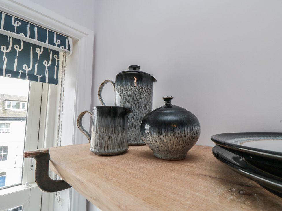 A teapot, milk jug, and sugar bowl on a wooden shelf at Cuckoo's Nest in Whitby