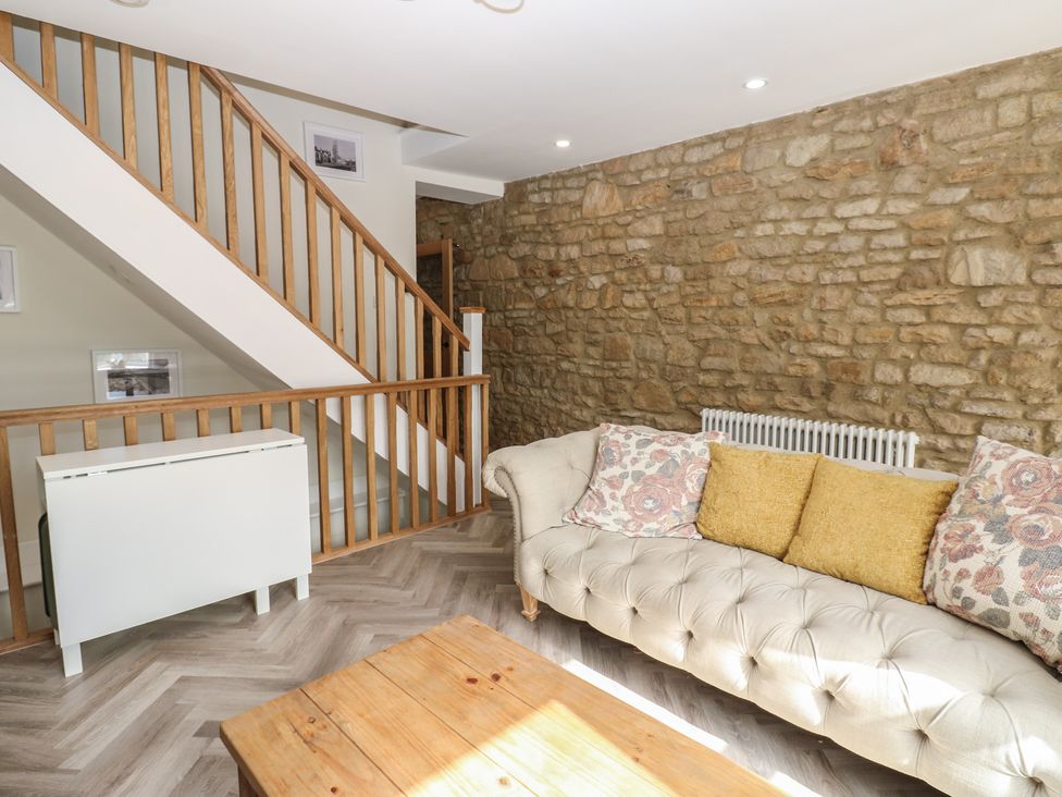 A living room with a sofa and coffee table at 2 Low Road