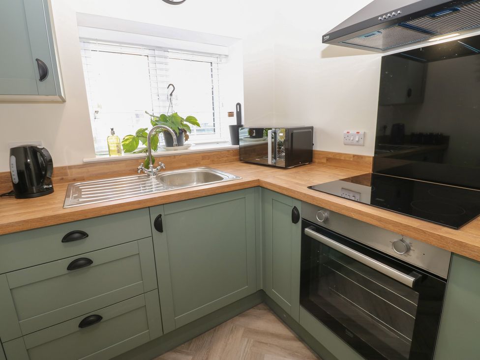 A kitchen featuring a sink and appliances at 2 Low Road