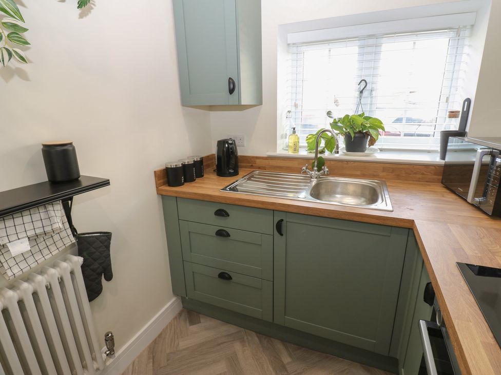 A kitchen with a sink and cabinets at 2 Low Road