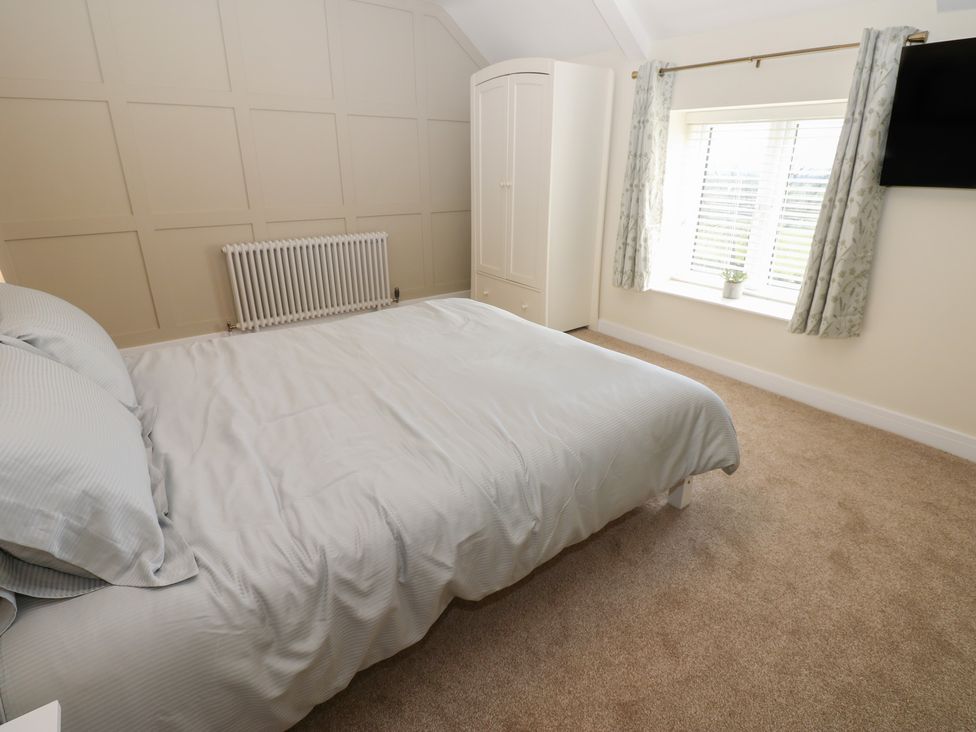 A bedroom with a bed and wardrobe at 2 Low Road
