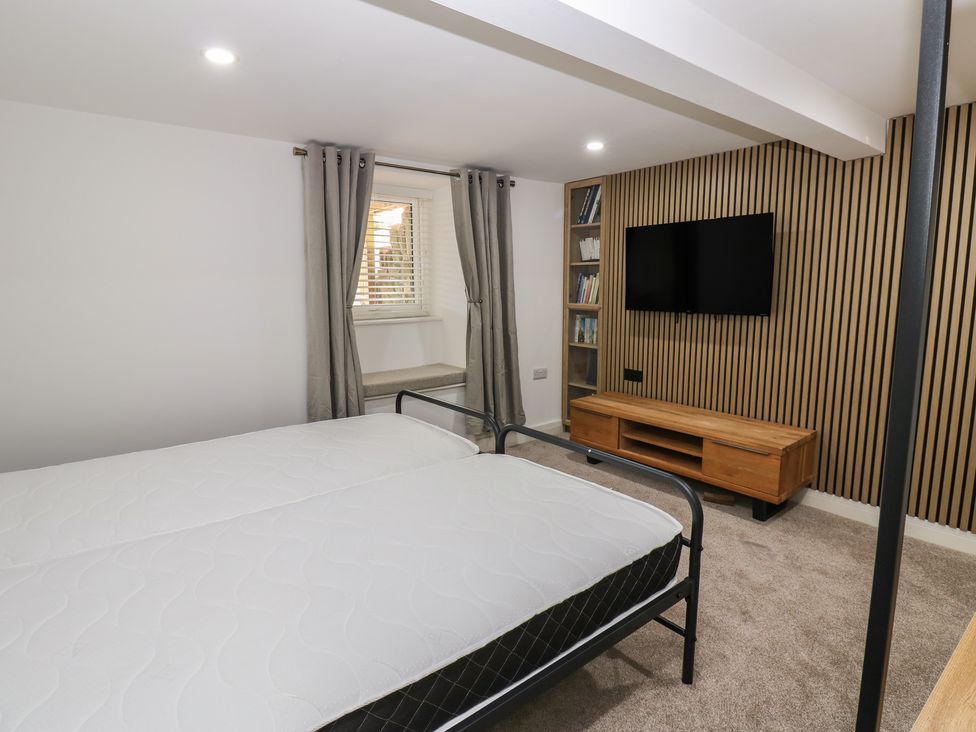 A bedroom with a bed and television at 2 Low Road