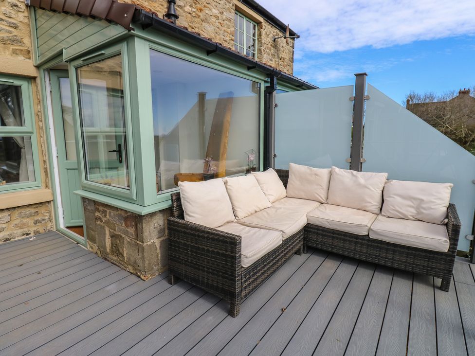 An outdoor seating area with a corner sofa at 2 Low Road 