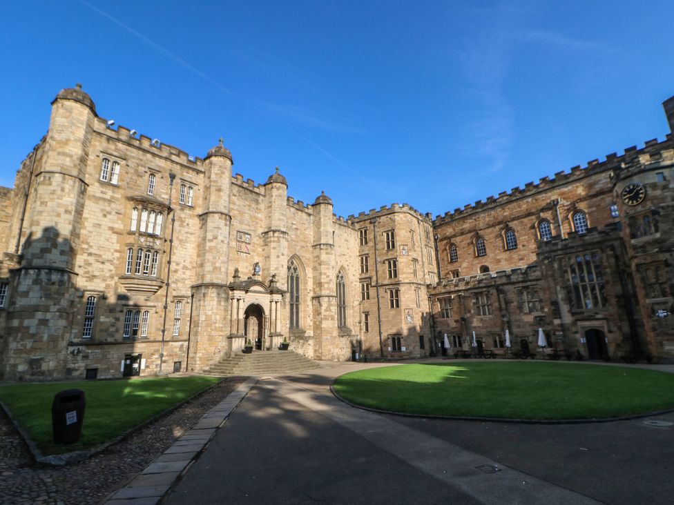 An outdoor view of a stone building with towers and a courtyard at 2 Low Road
