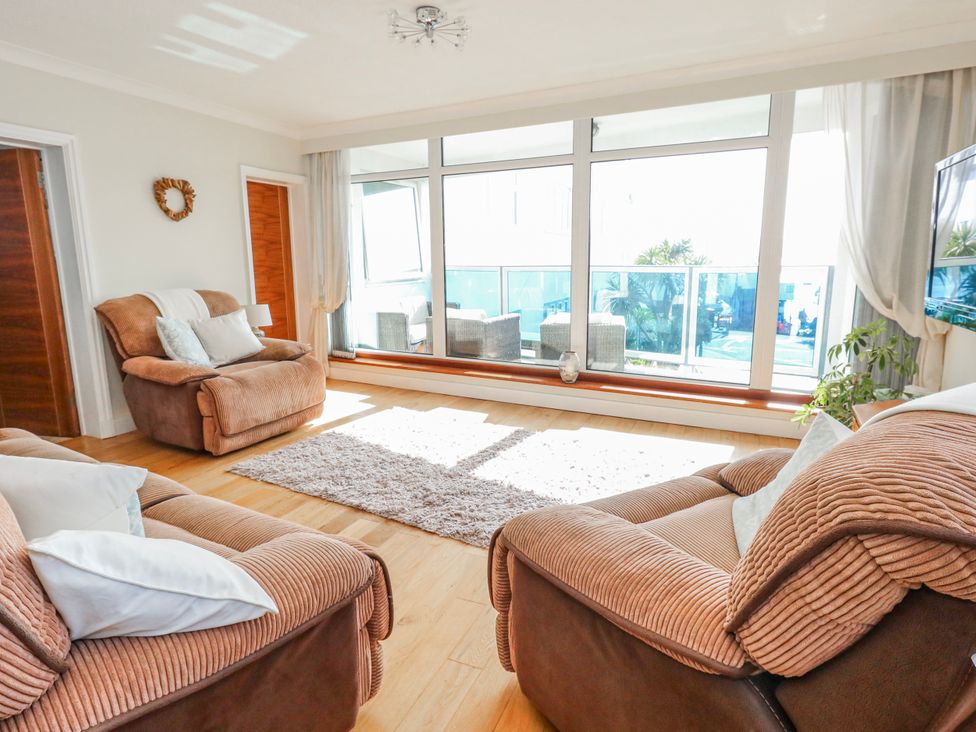A living room with a sofa and rug at Flat 17 Golden Gates in Poole