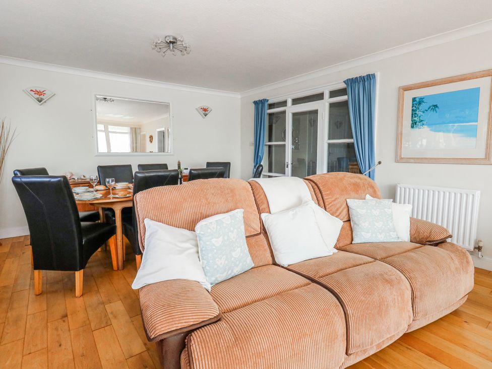 A dining room with a sofa and a dining table at Flat 17 Golden Gates in Poole
