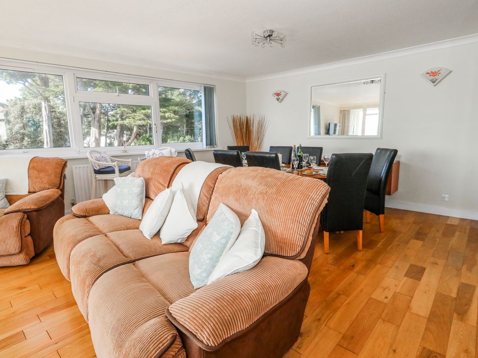 A living room with a sofa and a dining table at Flat 17 Golden Gates in Poole