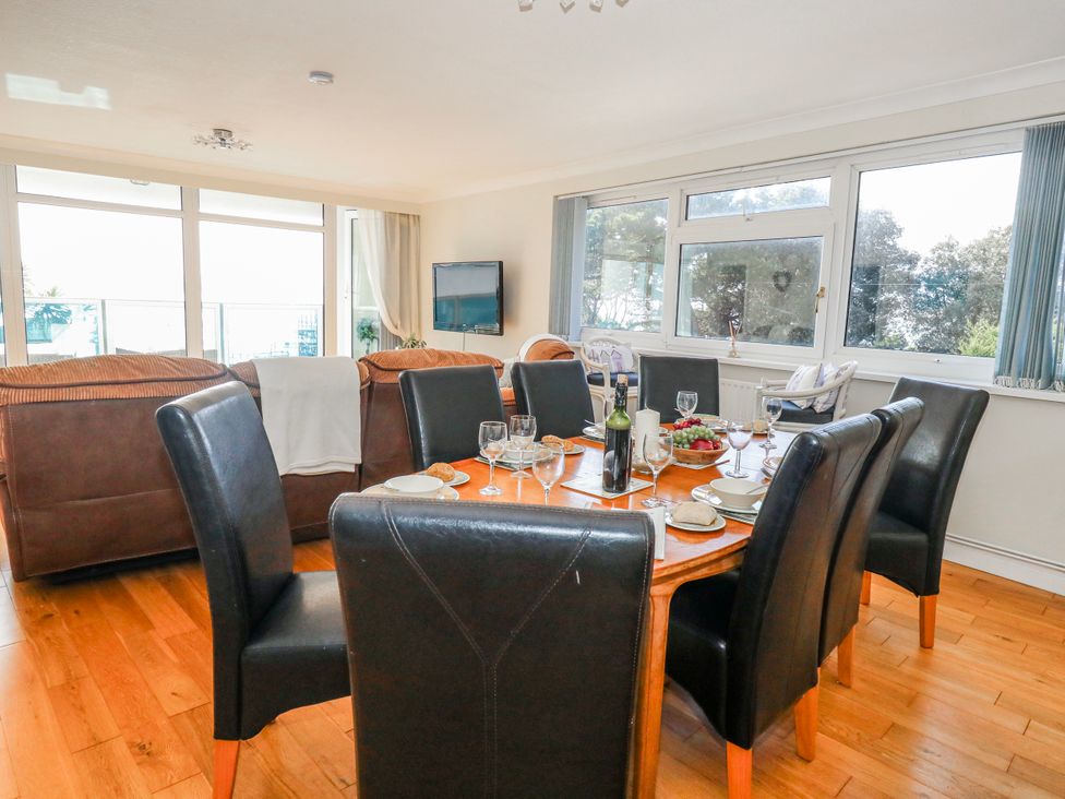 A dining room with a table set for a meal at Flat 17 Golden Gates in Poole