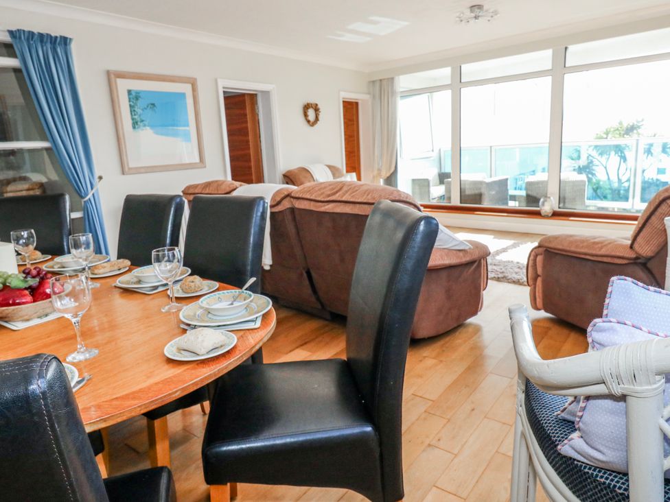 A dining room with a table set and seating area at Flat 17 Golden Gates in Poole