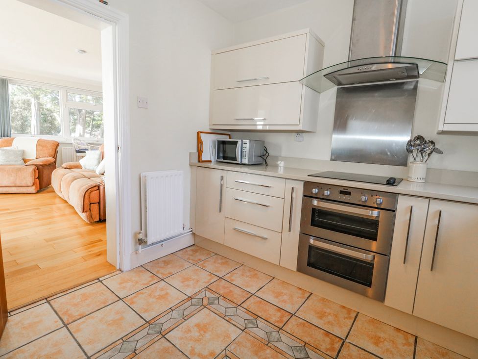 A kitchen with cabinets and appliances at Flat 17 Golden Gates in Poole