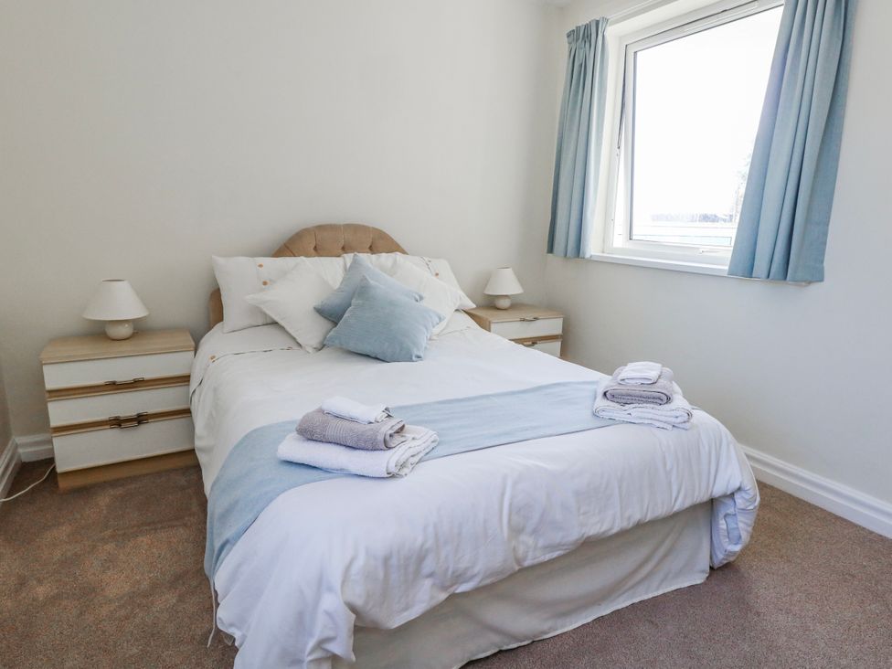 A bedroom with a bed and bedside table at Flat 17 Golden Gates in Poole