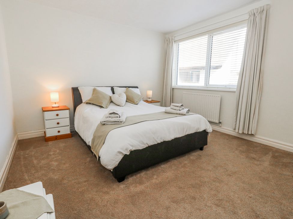 A bedroom with a bed and nightstand at Flat 17 Golden Gates in Poole