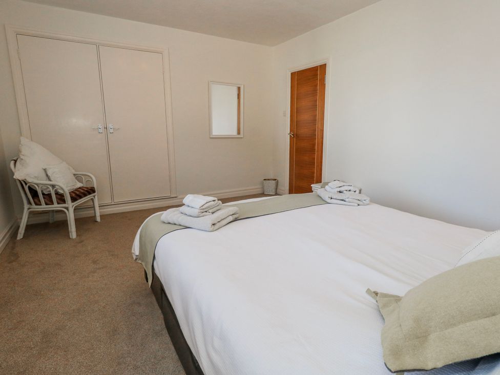 A bedroom with a bed and towels on it at Flat 17 Golden Gates in Poole