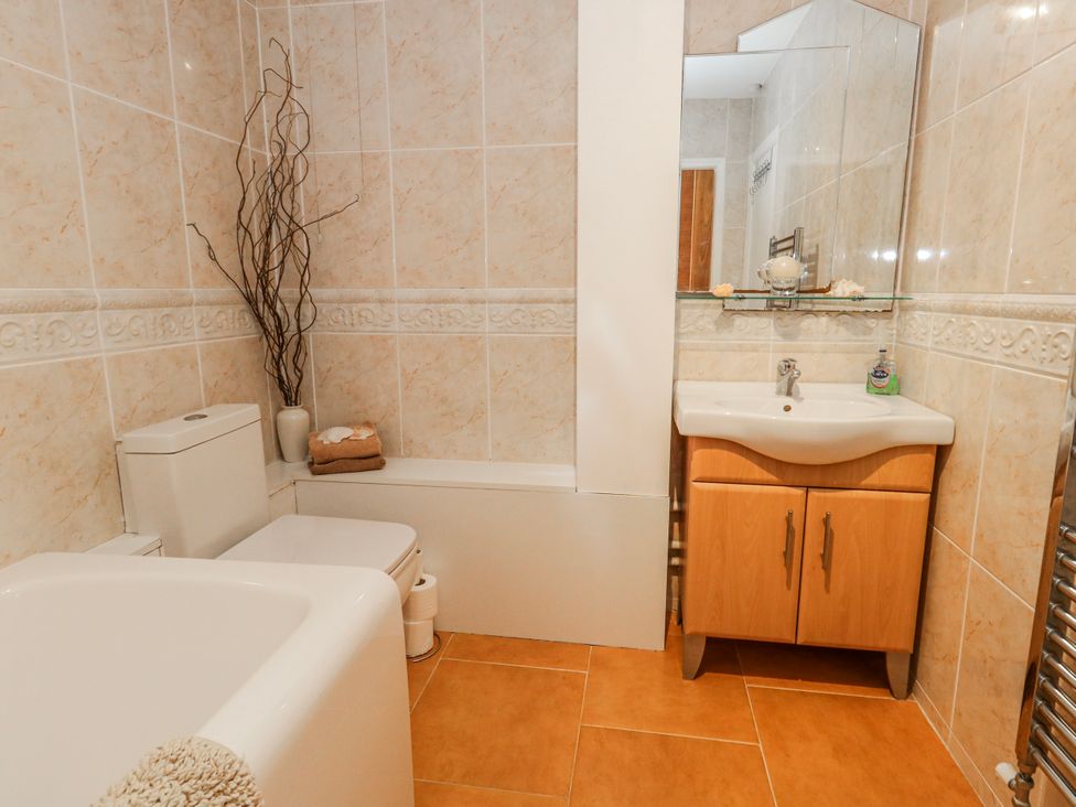 A bathroom with a sink, toilet, and bathtub at Flat 17 Golden Gates in Poole