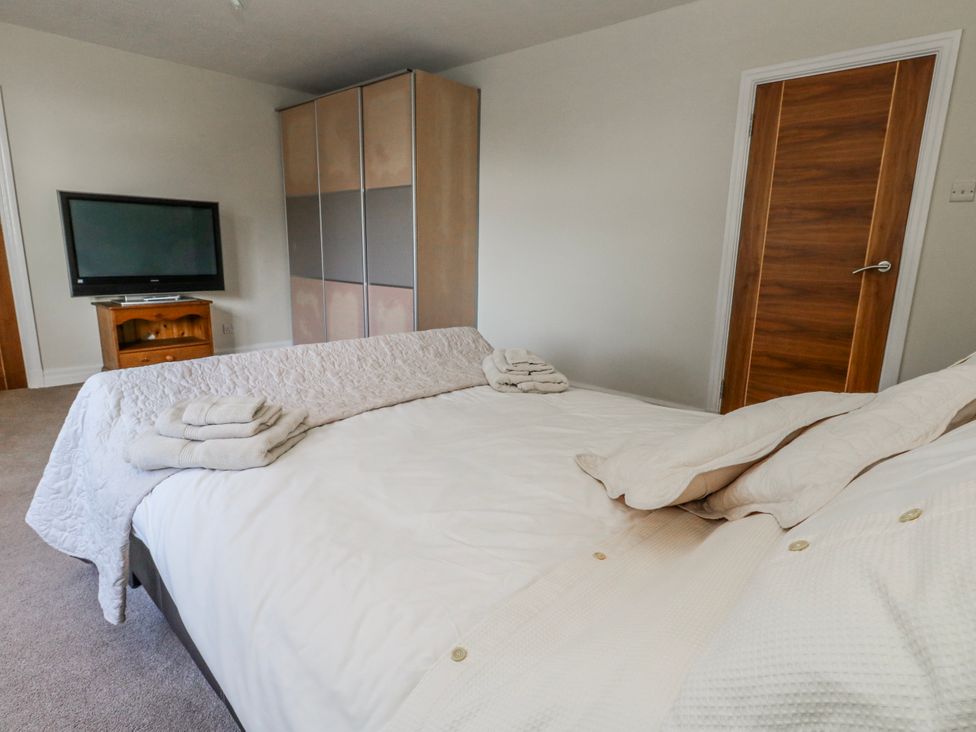 A bedroom with a bed and television at Flat 17 Golden Gates in Poole