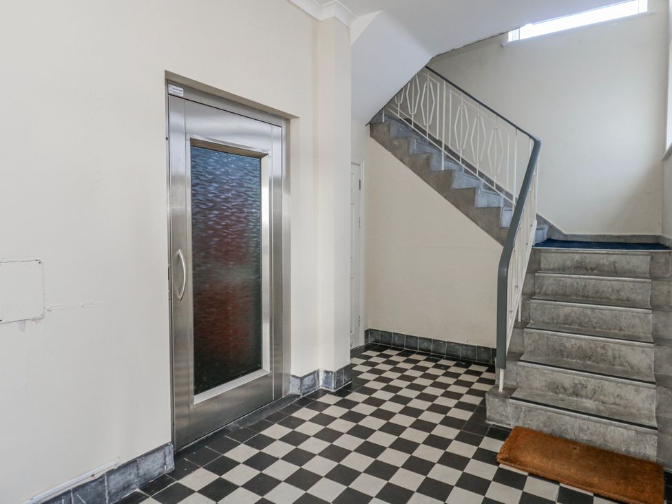 A hallway with an elevator and staircase at Flat 17 Golden Gates in Poole