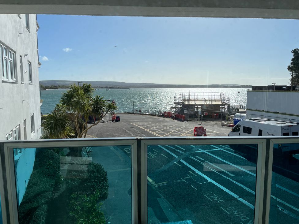 A view of the water and palm trees at Flat 17 Golden Gates in Sandbanks