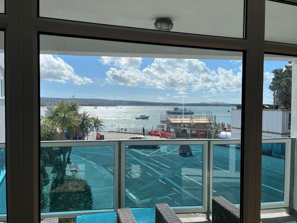 A view from a balcony showcasing water and boats at Flat 17 Golden Gates Sandbanks
