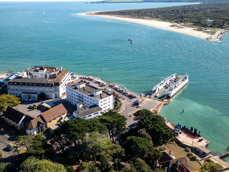 An aerial view of a ferry terminal with buildings and parking at Flat 17 Golden Gates Sandbanks