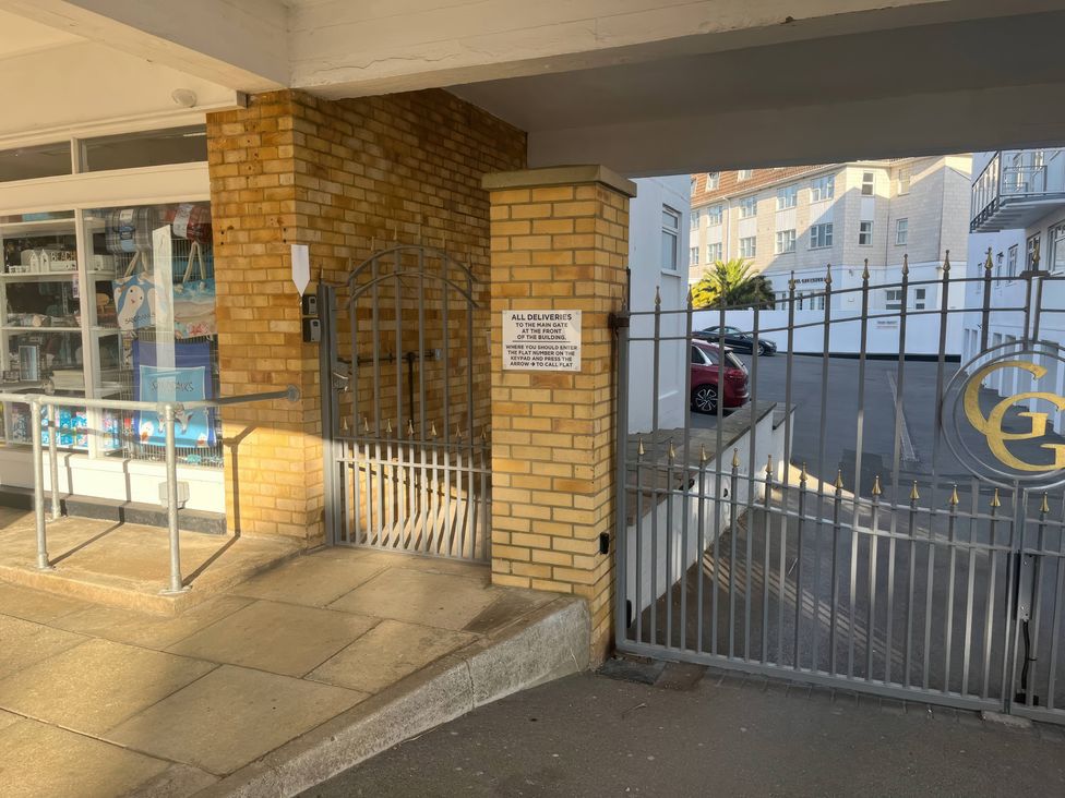 An outdoor entrance with a gate and sign at Flat 17 Golden Gates in Sandbanks