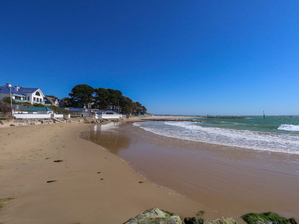 A beach with houses and trees at Flat 17 Golden Gates in Sandbanks