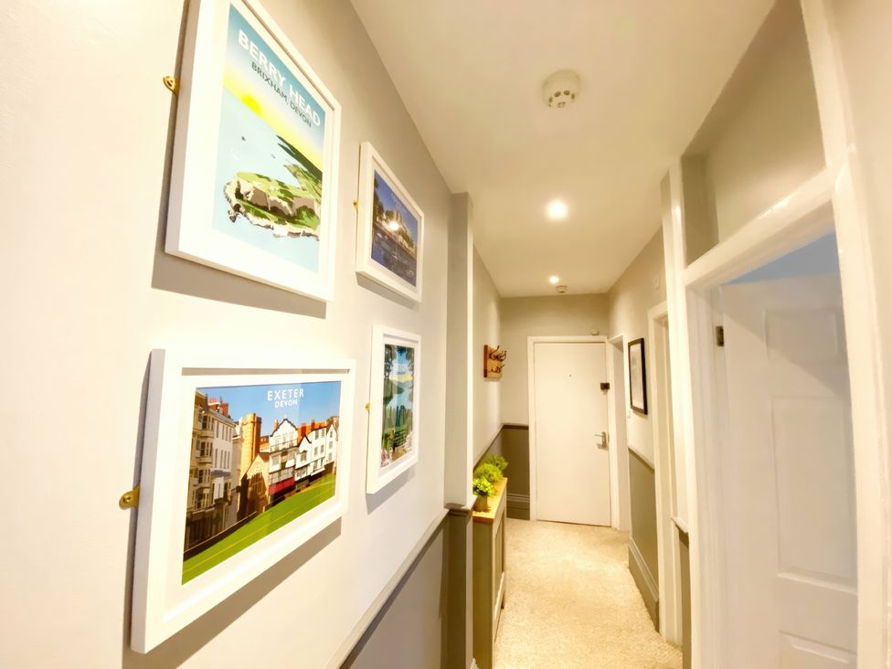 A hallway with framed pictures on the wall at 2A Redcliffe in Torquay