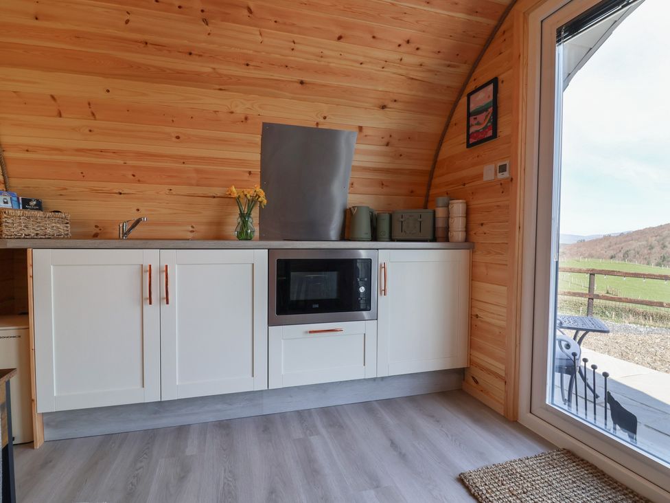 A kitchen with a microwave and sink at Cennin Pedr in Ruthin