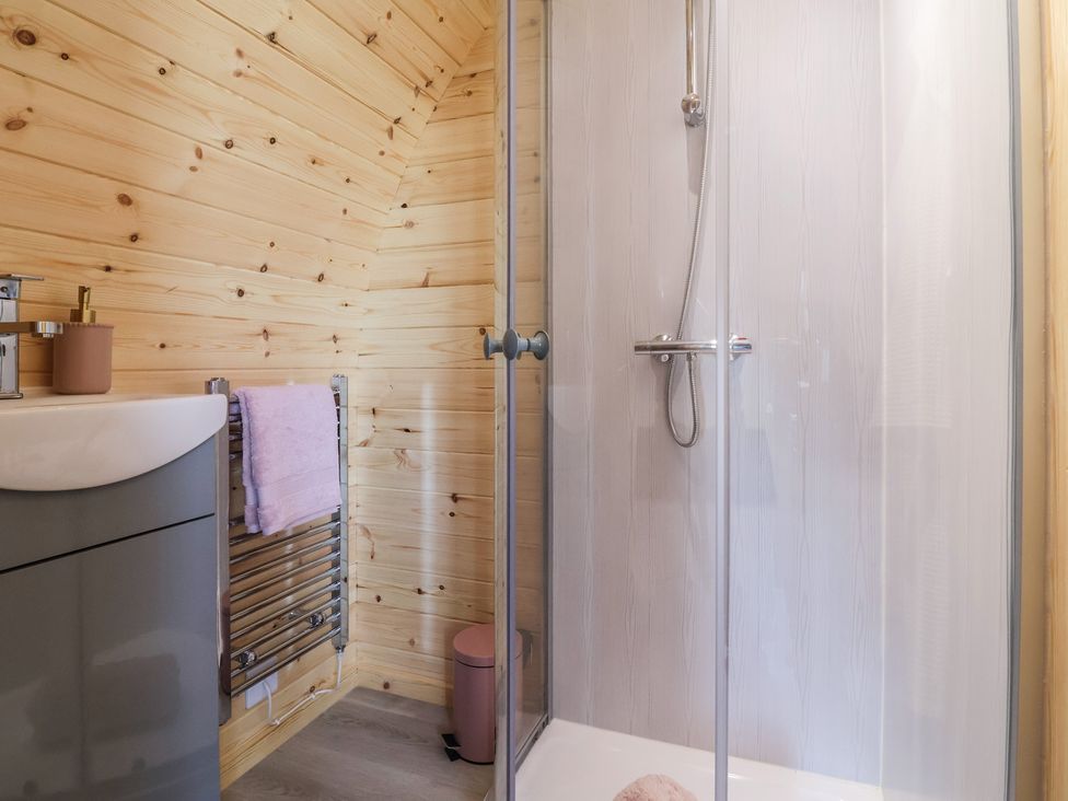 A bathroom with a shower and sink at Cennin Pedr in Ruthin