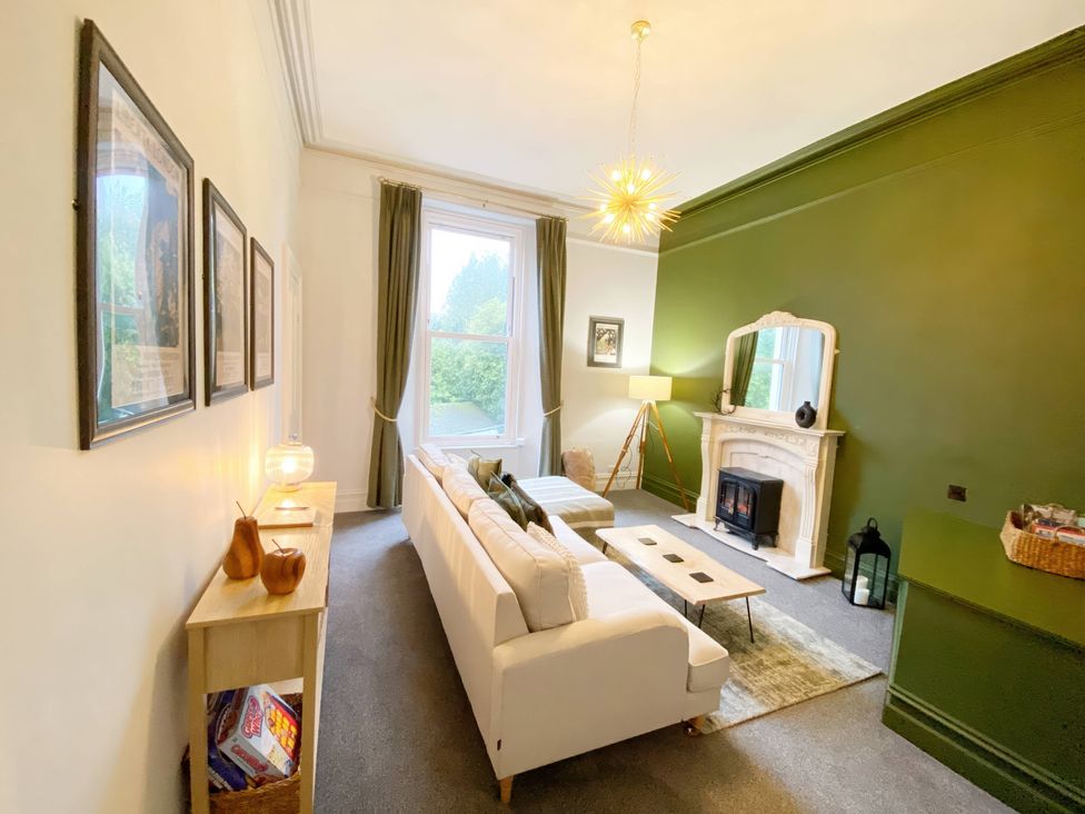 A living room with a fireplace and sofa at 2B Redcliffe Torquay