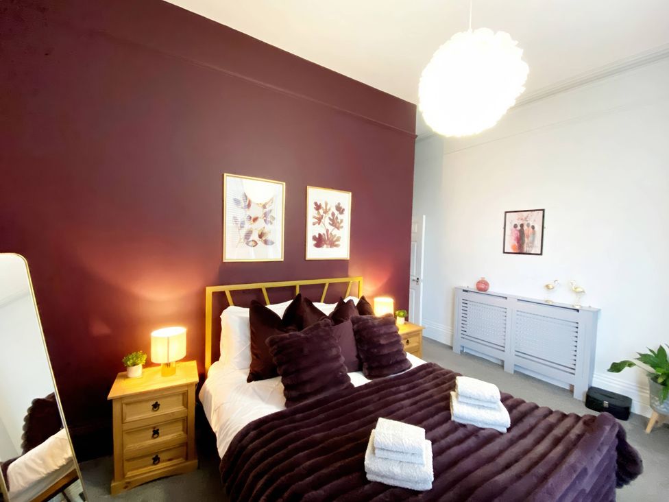 A bedroom with a bed and decorative items at 2B Redcliffe in Torquay