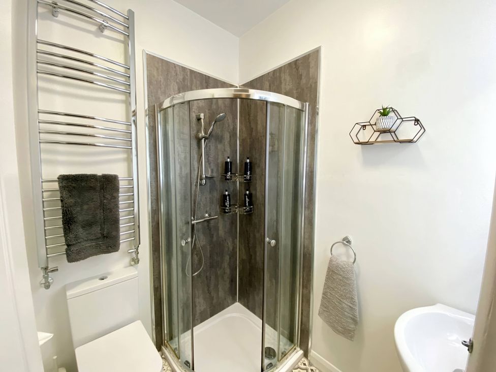 A bathroom featuring a shower and toilet at 2B Redcliffe in Torquay