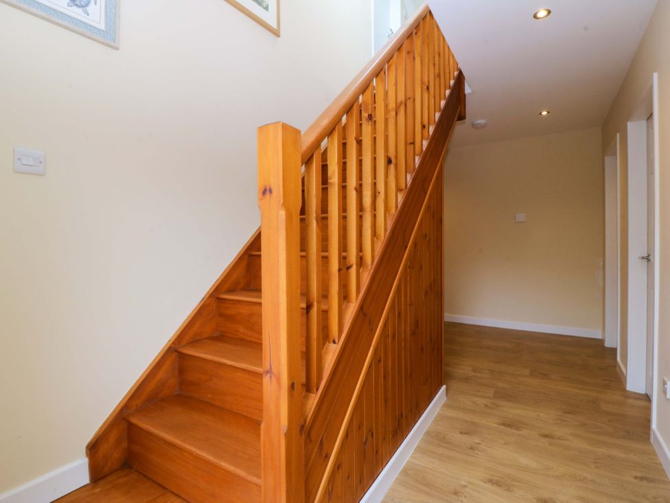 A staircase in a hallway at 5 Ger Afon Llanbedrog