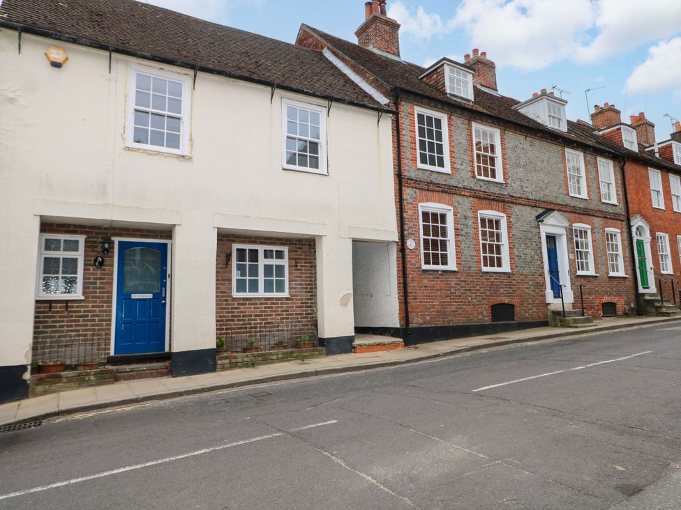 A row of houses with blue doors and brick walls at 19 Queen Street Emsworth