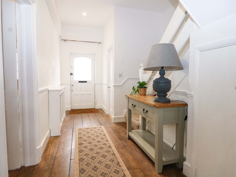 A hallway with a console table and lamp at 19 Queen Street, Emsworth