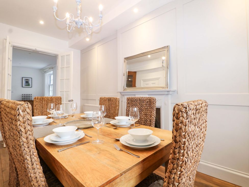 A dining room with a wooden table and chairs at 19 Queen Street Emsworth