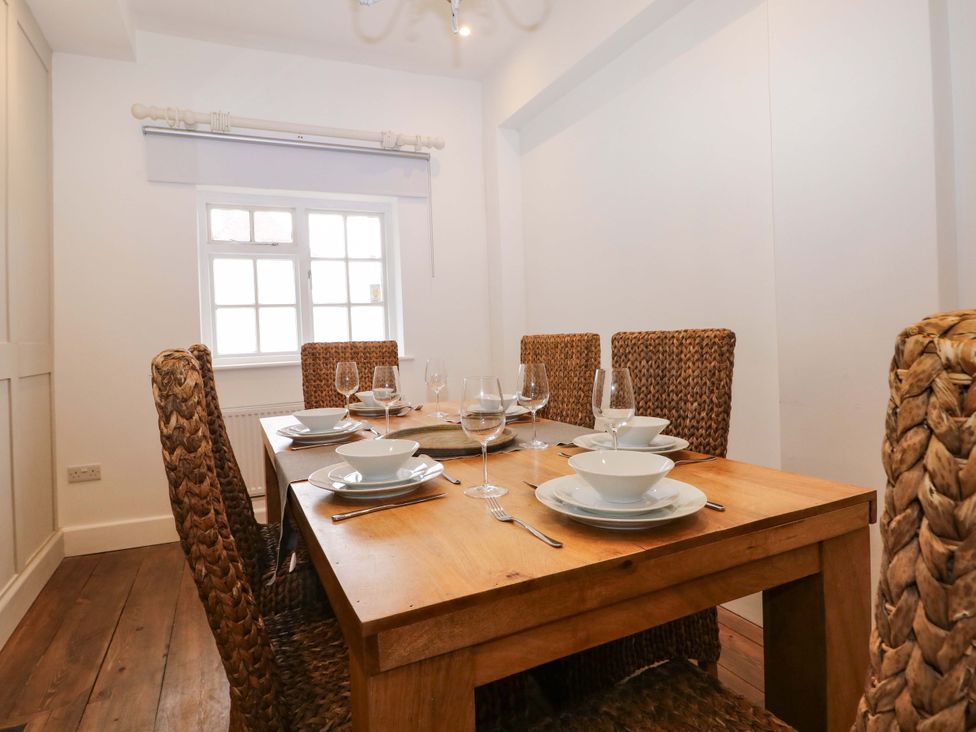 A dining room with a table set for meals at 19 Queen Street Emsworth